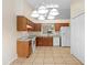 Open concept kitchen with white appliances, tile floors, and ample countertop space at 910 Sheeler Oaks Dr, Apopka, FL 32703