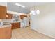Functional kitchen with tile flooring, oak cabinets, and modern appliances at 910 Sheeler Oaks Dr, Apopka, FL 32703