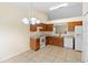Bright kitchen features tile floors, wood cabinets, and white appliances at 910 Sheeler Oaks Dr, Apopka, FL 32703