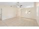 Open-concept living room features tile flooring, a ceiling fan, and a window at 910 Sheeler Oaks Dr, Apopka, FL 32703
