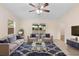 Bright living room featuring neutral walls, a ceiling fan, and sliding glass doors to the backyard at 910 Sheeler Oaks Dr, Apopka, FL 32703