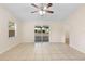 Inviting living room with sliding glass doors, a ceiling fan, and tile floors at 910 Sheeler Oaks Dr, Apopka, FL 32703