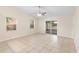 Bright living room featuring tile flooring, sliding glass doors, and natural lighting at 910 Sheeler Oaks Dr, Apopka, FL 32703
