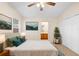 Calm main bedroom featuring carpet floors, ceiling fan, and ensuite bathroom access at 910 Sheeler Oaks Dr, Apopka, FL 32703