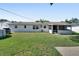 Expansive backyard showcasing the home's exterior, a screened patio, and an above-ground pool at 920 Trafalgar St, Deltona, FL 32725