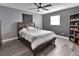 Comfortable bedroom features a wooden bed frame, ceiling fan, and a large window for natural light at 920 Trafalgar St, Deltona, FL 32725