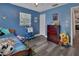Vibrant bedroom with blue walls, playful decor, and functional furniture at 920 Trafalgar St, Deltona, FL 32725