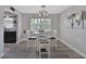 Stylish dining area with wood floors, modern lighting, and access to the kitchen at 920 Trafalgar St, Deltona, FL 32725