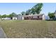 Single-story home with a spacious front yard, brick accents, a long driveway, and an attached garage at 920 Trafalgar St, Deltona, FL 32725