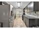 Modern kitchen features stainless steel appliances, stone backsplash, and an adjacent dining area at 920 Trafalgar St, Deltona, FL 32725