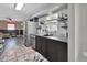 Contemporary kitchen with dark cabinets, stainless steel appliances, and convenient access to the living area at 920 Trafalgar St, Deltona, FL 32725