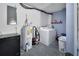 Functional laundry room with a washer, dryer, water heater, and storage at 920 Trafalgar St, Deltona, FL 32725