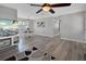 Bright open living room with wood floors, contemporary furnishings, and adjacent dining area at 920 Trafalgar St, Deltona, FL 32725