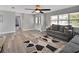 Comfortable living room featuring wood floors, a ceiling fan, and a neutral color palette at 920 Trafalgar St, Deltona, FL 32725