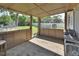 Covered patio features a view of the backyard with an above-ground pool and dining area at 920 Trafalgar St, Deltona, FL 32725