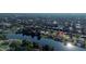 Wide aerial view of a quiet, residential neighborhood near a lake with tree lined streets at 928 Chickadee Dr, Port Orange, FL 32127