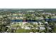 Aerial view of a house on a lake, highlighting the property's location within a quiet, green neighborhood at 928 Chickadee Dr, Port Orange, FL 32127