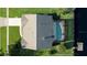 Aerial view of a house with a pool, showcasing its layout, surrounding landscaping, and proximity to the water at 928 Chickadee Dr, Port Orange, FL 32127