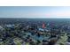 Expansive aerial view showcasing a tranquil lake community, lush landscapes, and city skyline on the horizon at 928 Chickadee Dr, Port Orange, FL 32127