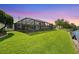 Expansive backyard with a screened pool enclosure and lush green lawn, ideal for outdoor activities and relaxation at 928 Chickadee Dr, Port Orange, FL 32127
