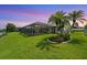 Lush backyard featuring a screened-in pool area, green grass, and mature trees, creating a private oasis at 928 Chickadee Dr, Port Orange, FL 32127