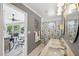 Bathroom with double vanity, garden accents and an open doorway to a screened patio and pool at 928 Chickadee Dr, Port Orange, FL 32127