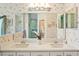 Bathroom features a double vanity, a large mirror, and floral wallpaper at 928 Chickadee Dr, Port Orange, FL 32127