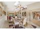 Light-filled dining room with a unique ceiling fan, artwork, and view into the living room at 928 Chickadee Dr, Port Orange, FL 32127