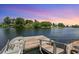 A charming wooden dock extends over the tranquil waters, offering a serene spot for boating and enjoying nature at 928 Chickadee Dr, Port Orange, FL 32127