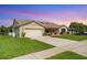Attractive single story home with two-car garage, neutral color palette, and manicured landscaping at 928 Chickadee Dr, Port Orange, FL 32127