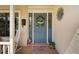 Charming blue front door with decorative wreath and sidelights, complemented by a welcoming mat at 928 Chickadee Dr, Port Orange, FL 32127