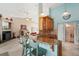 Bright kitchen with granite countertops, wooden cabinetry, and an eat-in bar area at 928 Chickadee Dr, Port Orange, FL 32127