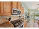 Kitchen featuring granite counters, stainless steel appliances, and a breakfast nook with pool view at 928 Chickadee Dr, Port Orange, FL 32127