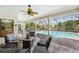 Screened lanai with comfortable seating overlooking a beautiful in-ground pool at 928 Chickadee Dr, Port Orange, FL 32127