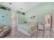 Bright main bedroom with coastal decor and a view into the main bath at 928 Chickadee Dr, Port Orange, FL 32127