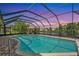 Inviting pool within a screened enclosure with ample patio space, a lounge, and clear blue water at 928 Chickadee Dr, Port Orange, FL 32127