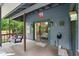 Cozy back porch with a swing and sliding glass doors to the interior at 96 Hollow Branch Xing, Ormond Beach, FL 32174