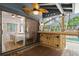 Back porch with a wet bar and ceiling fans overlooks the pool at 96 Hollow Branch Xing, Ormond Beach, FL 32174