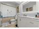 Bathroom with white vanity, framed mirror and bathtub with shower at 96 Hollow Branch Xing, Ormond Beach, FL 32174