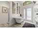 Bathroom featuring a soaking tub, walk-in shower, and double vanity with mirrors at 96 Hollow Branch Xing, Ormond Beach, FL 32174