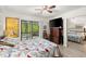 Bedroom with sliding glass doors leading to the outside, and a mirrored closet at 96 Hollow Branch Xing, Ormond Beach, FL 32174