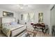 Bright bedroom featuring a ceiling fan, artwork, and decorative accents at 96 Hollow Branch Xing, Ormond Beach, FL 32174
