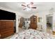 Bedroom with ceiling fan, mirrored closet and a large television at 96 Hollow Branch Xing, Ormond Beach, FL 32174