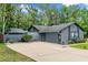 Well maintained exterior of home with a large driveway and mature landscaping at 96 Hollow Branch Xing, Ormond Beach, FL 32174
