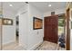 Inviting home foyer featuring a wood front door, light tile flooring, and neutral wall color at 96 Hollow Branch Xing, Ormond Beach, FL 32174