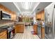 Stylish kitchen with wood cabinets, granite countertops, stainless steel appliances, and tile backsplash at 96 Hollow Branch Xing, Ormond Beach, FL 32174