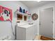 Laundry room featuring a washer, dryer, and upper shelving for supplies at 96 Hollow Branch Xing, Ormond Beach, FL 32174