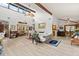 Open concept living space with vaulted ceilings, wood beams, modern lighting, and updated flooring at 96 Hollow Branch Xing, Ormond Beach, FL 32174
