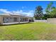 Expansive backyard featuring a screened lanai, lush lawn, and a convenient storage shed at 2600 Scottville Ave, Deltona, FL 32725