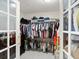 Walk-in closet featuring well-organized hanging clothes and shelving with a dark wood dresser, providing ample storage space at 2600 Scottville Ave, Deltona, FL 32725